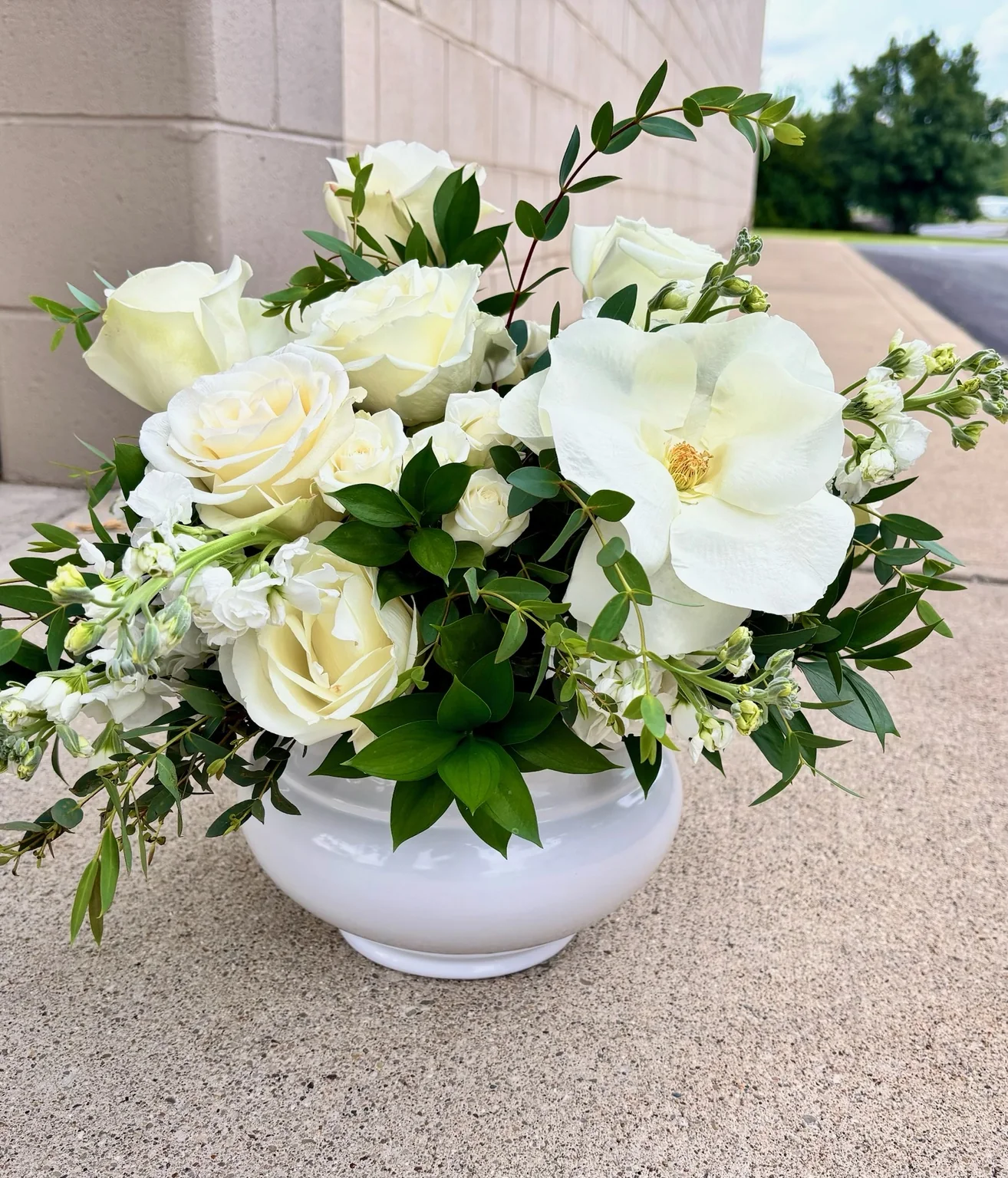 White garden-style memorial flower arrangement designed by A Ray of Sunshine Floral in Hilliard, Ohio